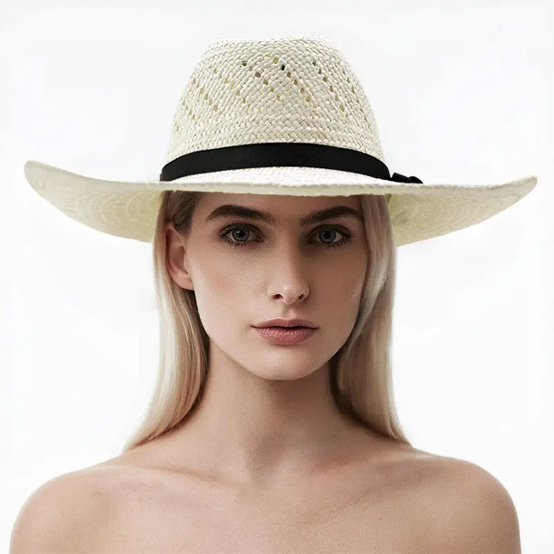 The model wears an off-white straw cowboy hat with a black band and decorative knot.