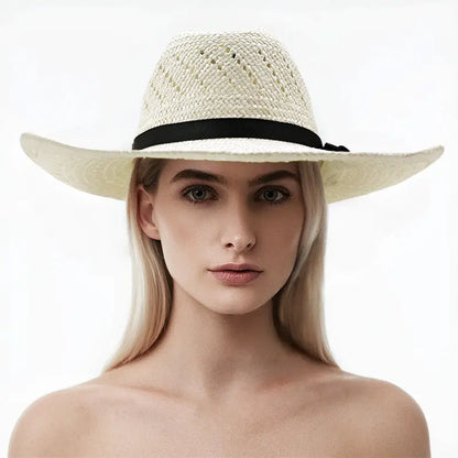 The model wears an off-white straw cowboy hat with a black band and decorative knot.