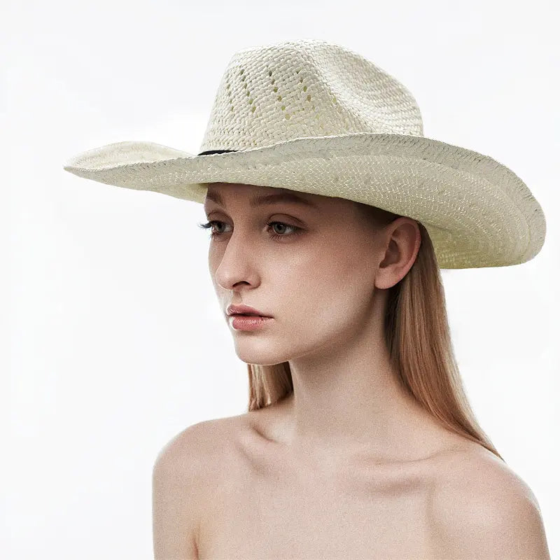 The model wears an off-white straw cowboy hat with a black band and decorative knot.