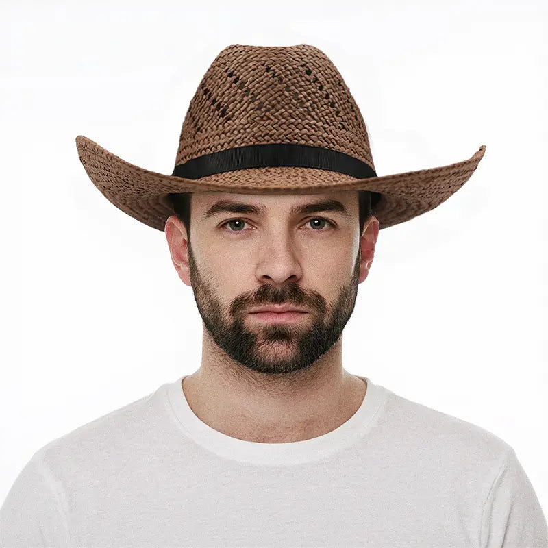 A man wearing a white shirt wears a brown straw cowboy hat with a black band.