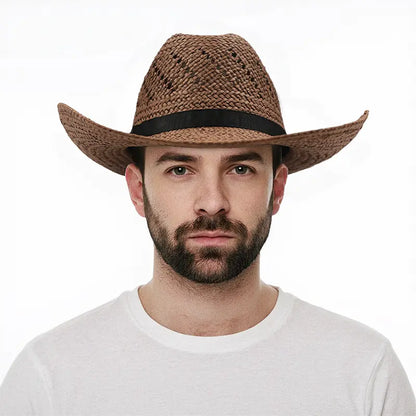 A man wearing a white shirt wears a brown straw cowboy hat with a black band.