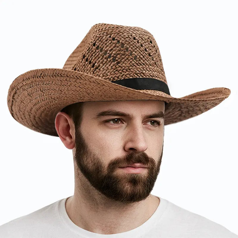 A man wearing a white shirt wears a brown straw cowboy hat with a black band.
