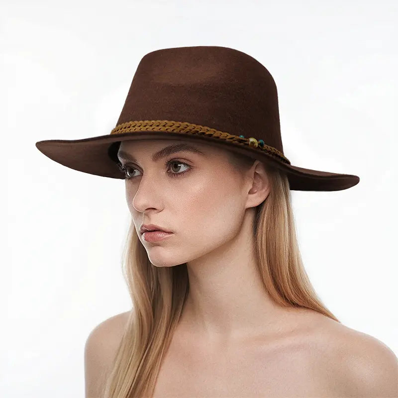 Model wears a brown felt wide-brimmed fedora hat with braided detailing