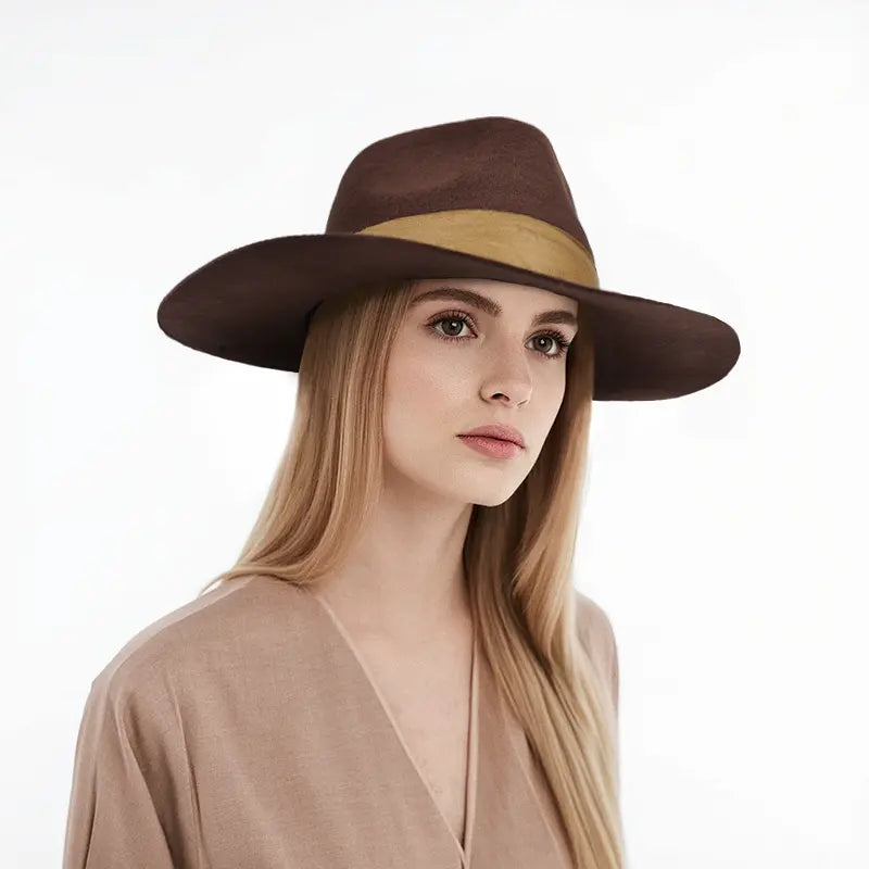 The model is wearing a brown felt wide-brimmed fedora hat with a tan band.