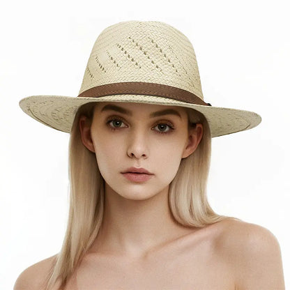 Woman with long blonde hair wearing a light beige woven straw hat with a brown band, set against a plain white background