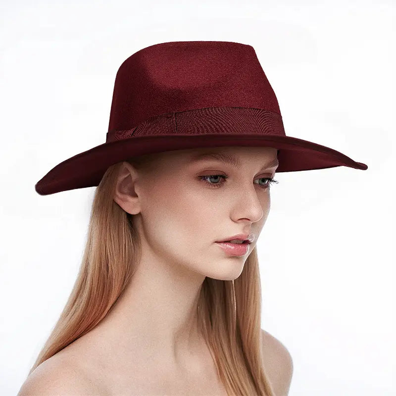 Woman wearing a maroon wide - brimmed hat with a dark band around the crown