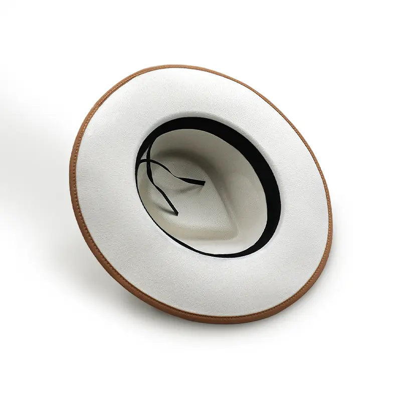 White wide - brimmed hat with brown trim around the brim and black inner lining with thin straps inside