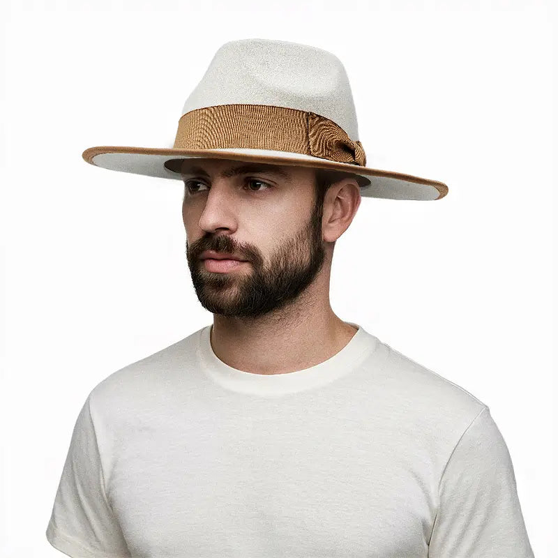 Man wearing a light gray wide - brimmed hat with brown band and brim trim, featuring a decorative knot on the band, paired with a white crewneck T - shirt