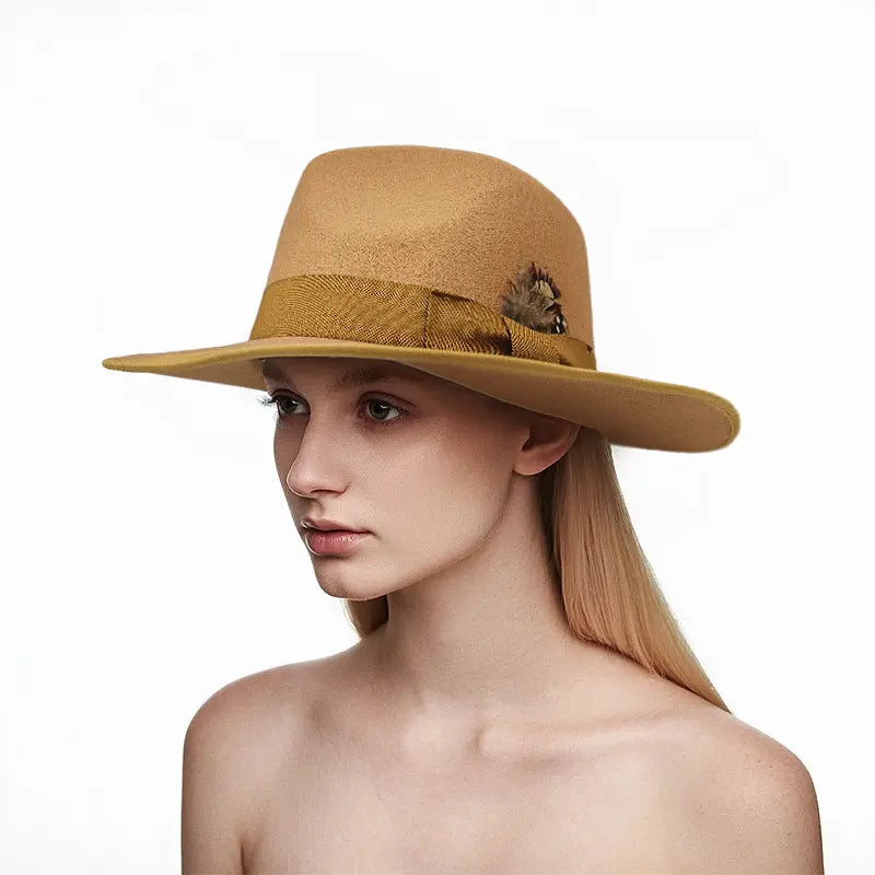 Woman wearing a tan wide - brimmed hat with feather and ribbon accents