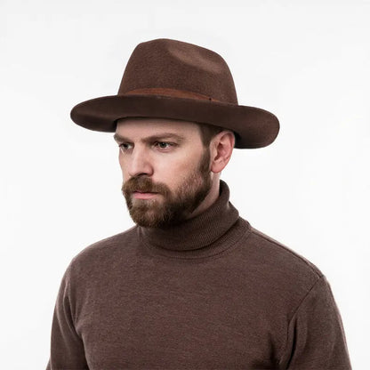 The man in the brown turtleneck sweater wears a brown felt fedora hat with a brown hatband.